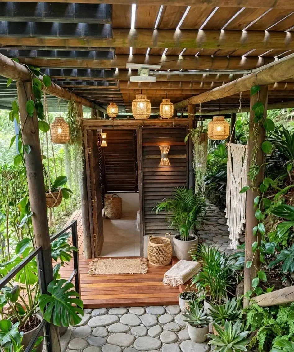 Outdoor ritual bathroom under the cabin, with river stones and plants
